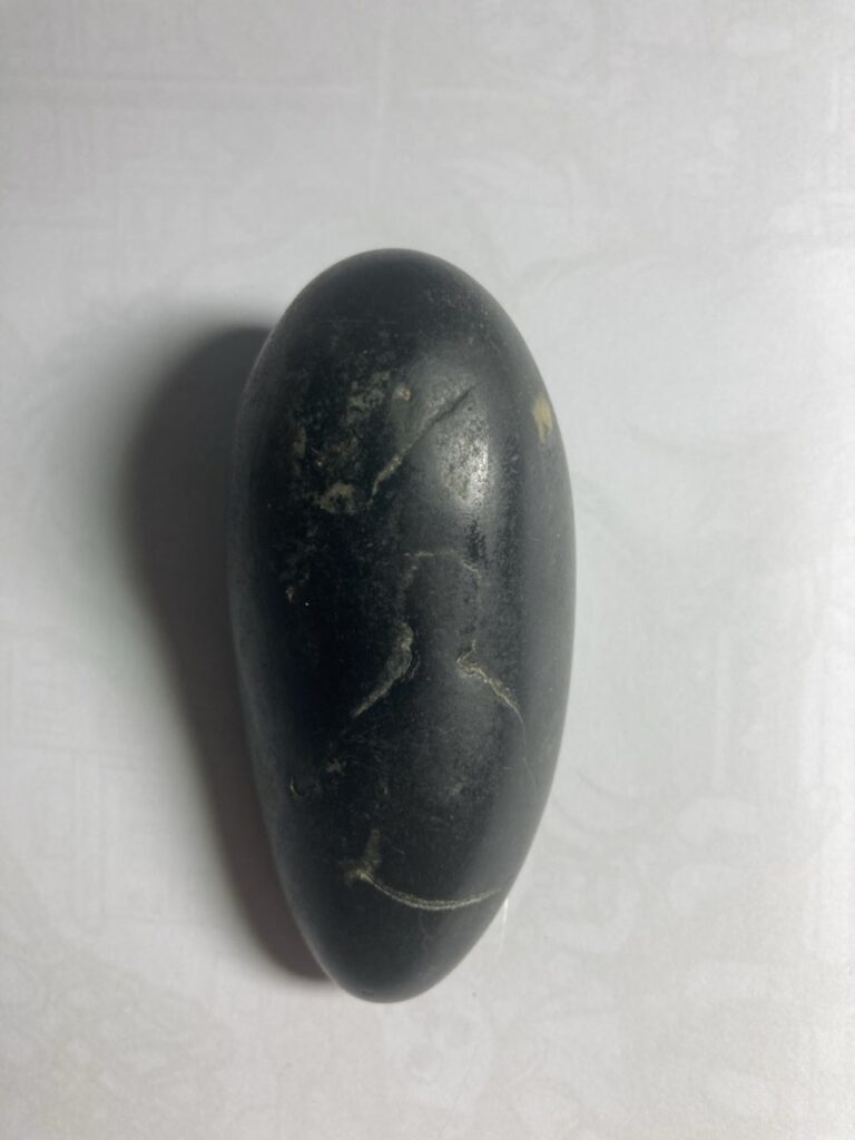 dark pebble symbolizing quiet reflection and inner strength