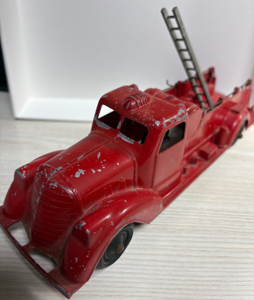 vintage red fire truck toy with metal ladder detail