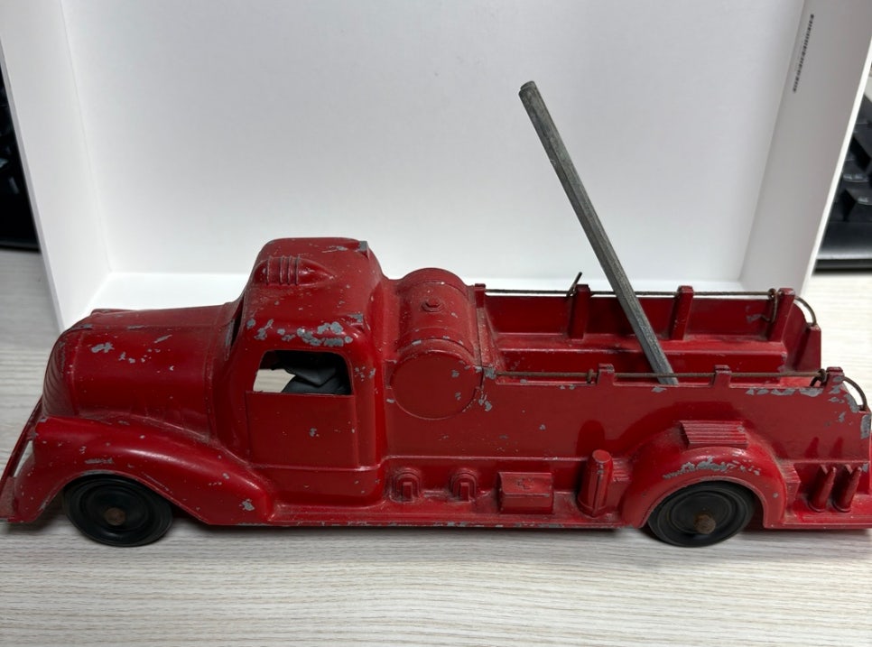 vintage red fire truck toy side view with ladder