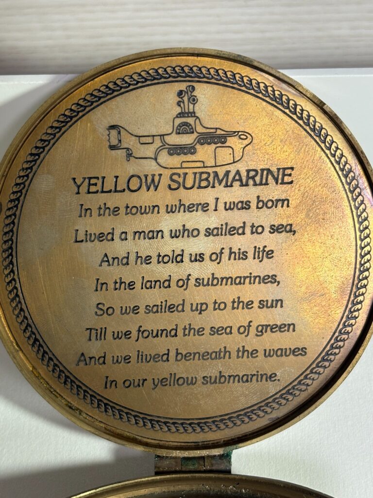 engraved Yellow Submarine lyrics inside vintage brass compass lid