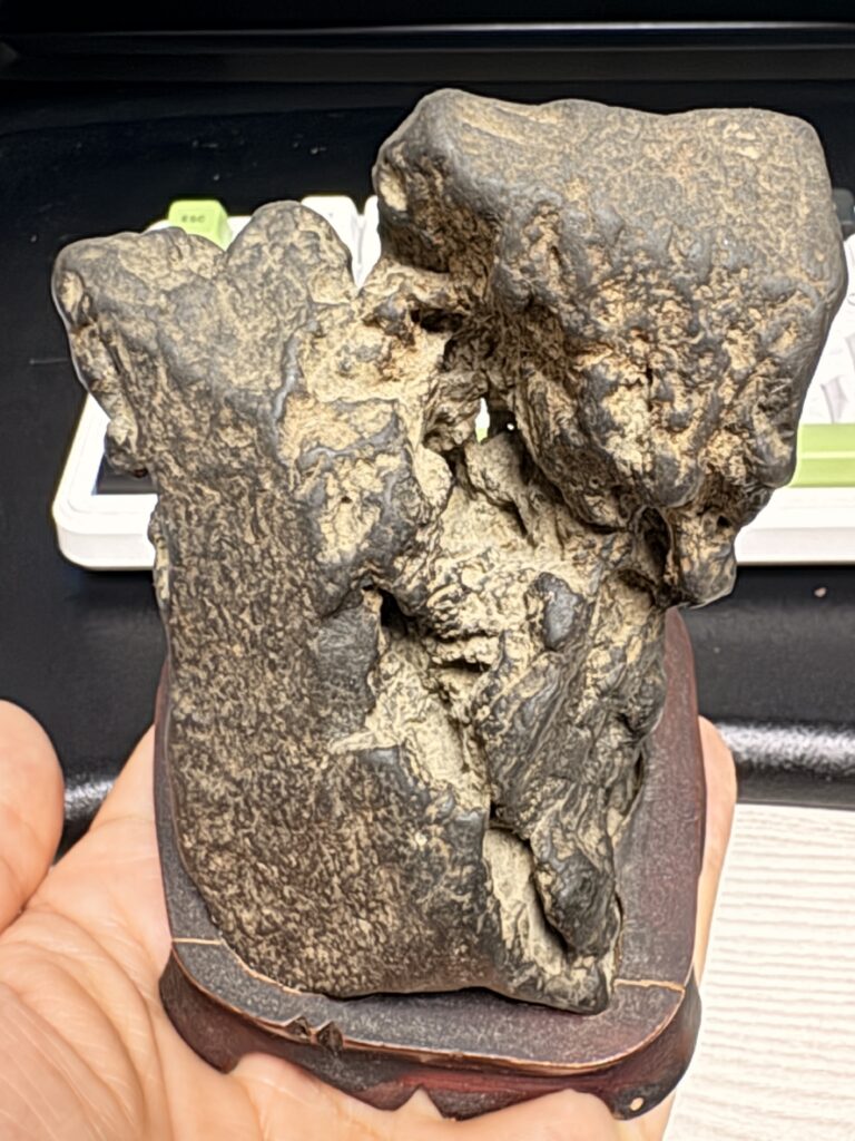 small naturally shaped viewing stone held in a hand